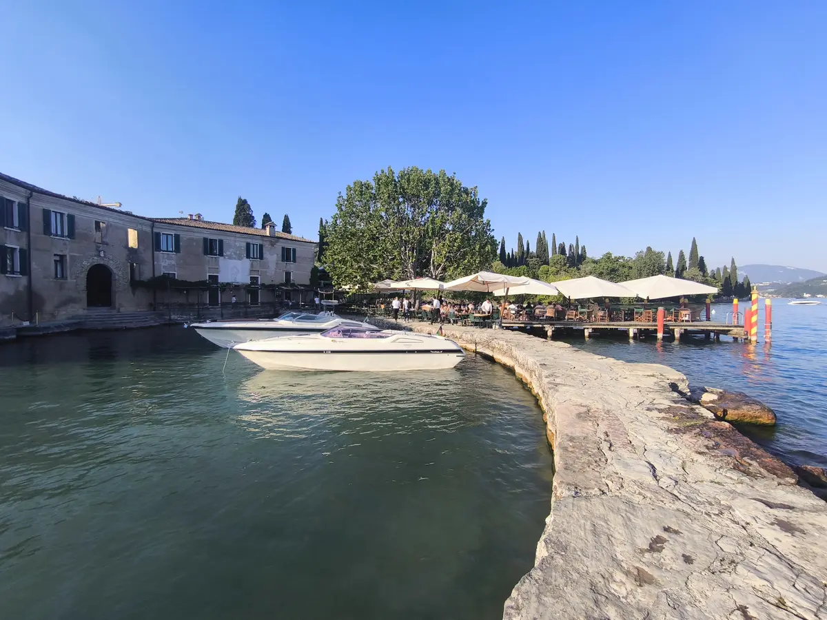 Punta San Vigilio lakefront bar and boats in the early evening