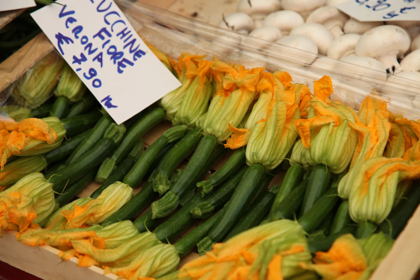 Fresh vegetables and zucchini flowers at a Lake Garda weekly market