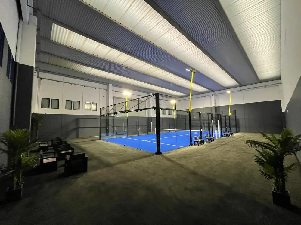Indoor courts and seating area at Padel Life Garda Lake