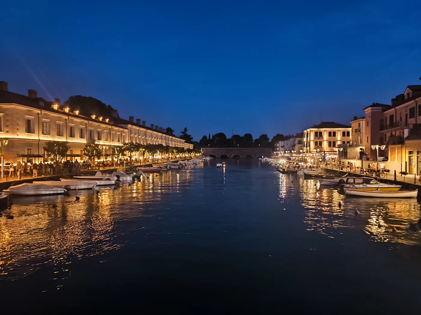Peschiera del Garda canal with lights reflected on the water at night