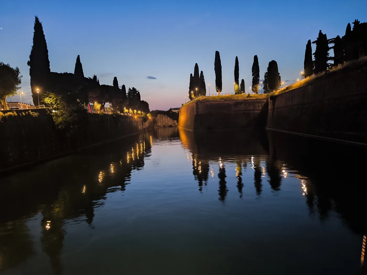 Fortified walls and water in Peschiera del Garda at dusk
