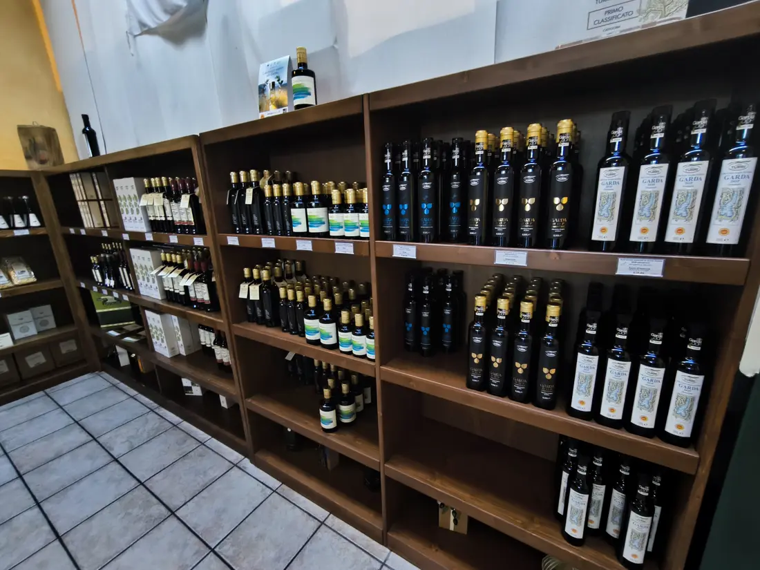 Shelves of Lake Garda olive oil bottles at an olive oil shop near Bardolino